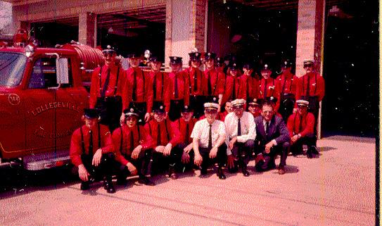 This photo shows Fire Chief Dennis Parker, Retired Chief Robert Moyer, Assistant Chief Joe Ippinger kneeling right front, Chief Engineer Mike Sarro kneeling 3rd from right, Assist Chief len Bibbs Jr. stand at right, President Howard Hunsicker in the suit kneeling.
Also in picture Gary Sassaman, Rick Opperman, Ken and Bob Miller, Charlie McCann, 