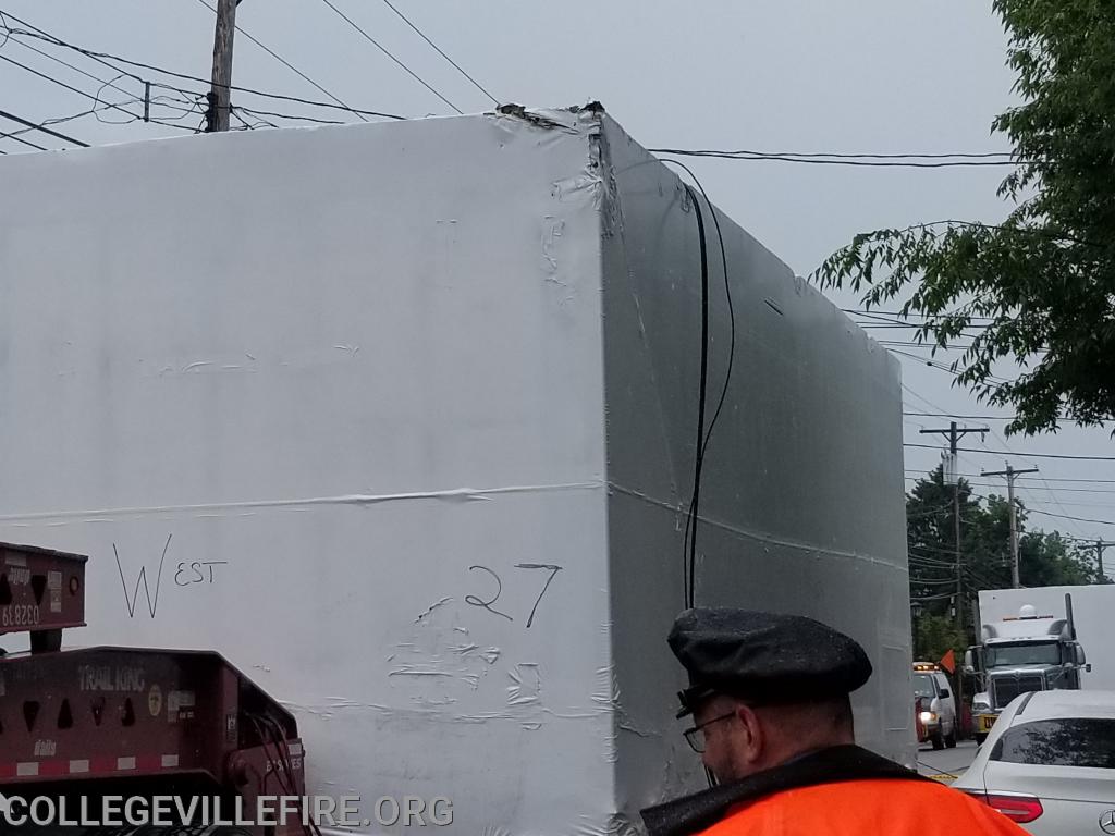 Over size load, pulls down wires and damages building in the 300 block of E. Main Street, Collegeville Borough.